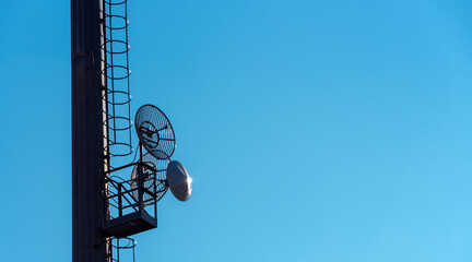 Telecommunication satellite dishes on blue sky, 5G concept, copy space, graphic resource for banner