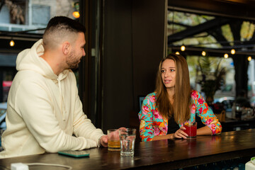 Fototapeta premium Talking to each other and drinking on the bar