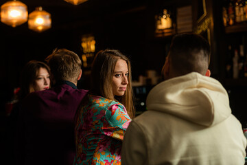 Two couples talking on the bar and having a great time while sitting