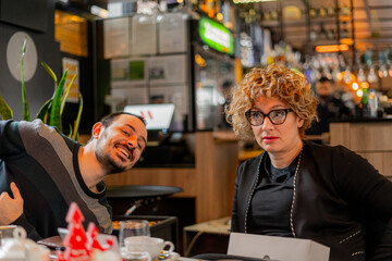 Talking while her assistent is smiling