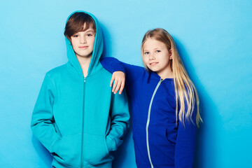 Cool kids. Portrait of a young boy and a young girl in the studio.