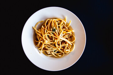 Closeup shot of a noodle dish on a white plate © Joose Laine/Wirestock Creators