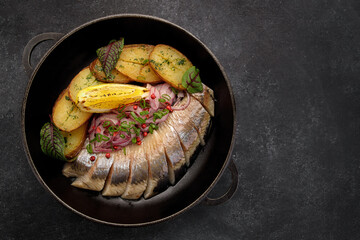 Pickled Herring with baked potatoes and onions
