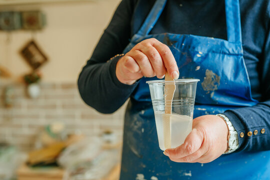 Woman prepairing ingredients for making clock in Resin art