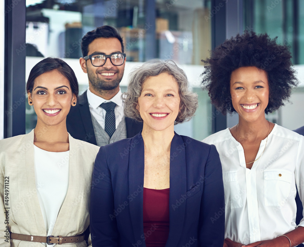 Aufkleber dedication is what makes a team work. portrait of a team of corporates standing together in an offic