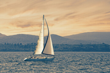 Beautiful Mediterranean landscape with sailing boat on water at sunset.  Montenegro, Kotor Bay....