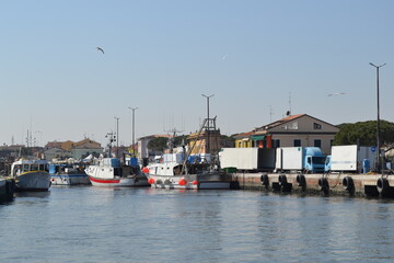 Fototapeta na wymiar We are located in Cesenatico, an Italian town in Romagna, on the coast of the Adriatic Sea. Details of the quay of the canal port.