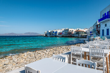 Mykonos, Greece. Tables and chairs by the waterfront in Little Venice, Mykonos Island. - obrazy, fototapety, plakaty
