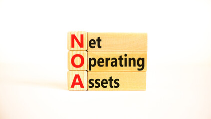 NOA net operating assets symbol. Concept words NOA net operating assets on wooden blocks on a beautiful white table, white background. Business and NOA net operating assets concept. Copy space.