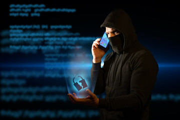 Scammer telephoning his victims while holding a broken padlock in his hand symbolizing breached security. Concept of vishing