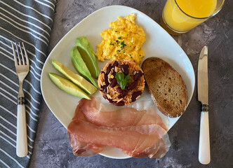 Gallo Pinto with rice and red kidney beans, served with scrambled eggs, proscuitto ham, avocado and toasted dark bread.