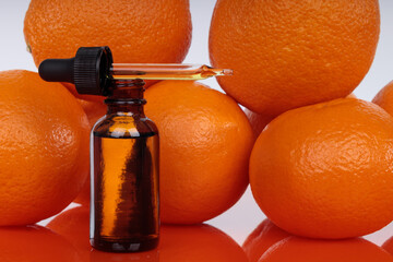 Orange extract has anti-cancer properties. A dropper on a background of fresh oranges. Natural...