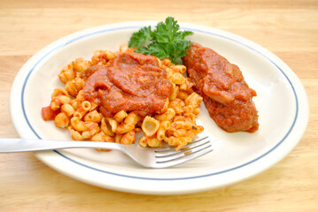 Shell and Elbow Pasta with Sauce and a Sausage on the Side	