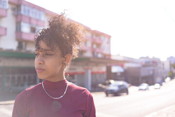 Black young woman portrait outdoors in urban landscape