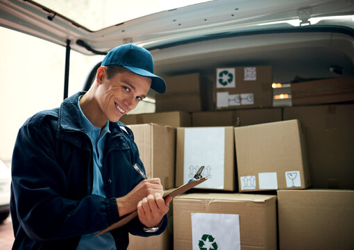 I make sure deliveries arrive on time. Cropped shot of a handsome young delivery man using a clipboard.