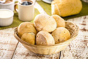 Brazilian breakfast, pão de queijo with coffee and cream cheese, served hot.