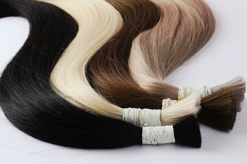 Hair samples for extension rolled up,different colors.White background.