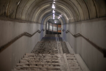 Staircase in snow. Pedestrian crossing across street. Lifting tunnel. Steps up.