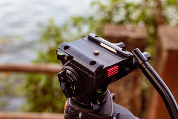 DSLR Camera photography and videography tripod head in an outdoor location with selective focus