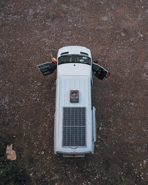 Vertical Top View Of A Parked RV Trailer Car With Open Doors