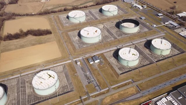 Aerial moving 4K view of an industrial area with a fossil oil storage facility

