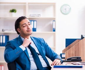 Young handsome businessman sitting in the office