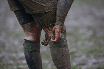 Closeup of a dirty rugby player in the field