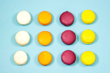 French Colorful Macaron Cookies isolated on blue background