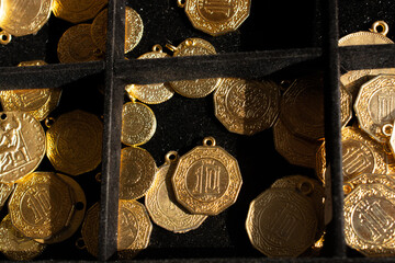 Closeup shot of gold coins on the black background