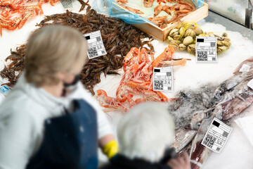 fishing supermarket and fishes with labels with qr code to show information on origin, type, specie, etc