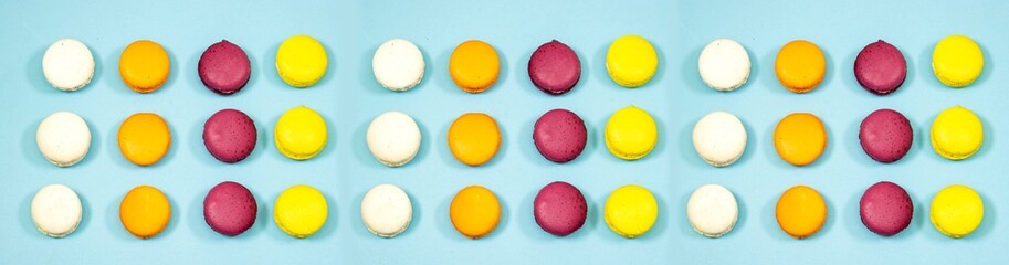 French Colorful Macaron Cookies isolated on blue background