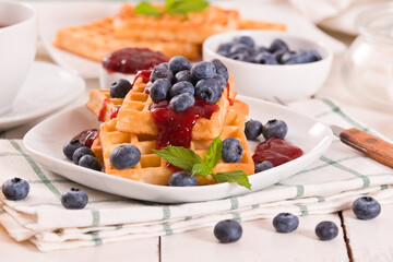 Waffles with blueberries and jam. 