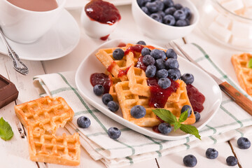 Waffles with blueberries and jam. 