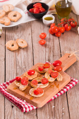 Friselle with cherry tomatoes and olive oil.