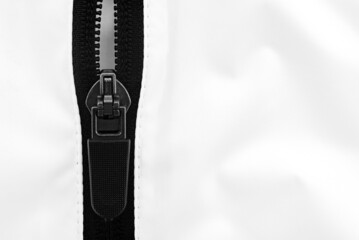 Lock with black zipper on white clothes. Jacket clasp © Gudman