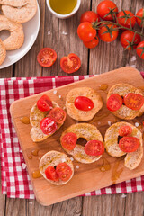 Friselle with cherry tomatoes and olive oil.