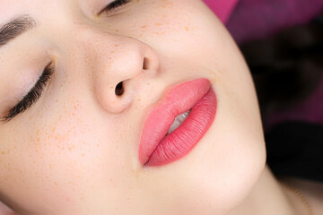 lip tattoo beautiful girl model with permanent makeup on lips red color photo after procedure