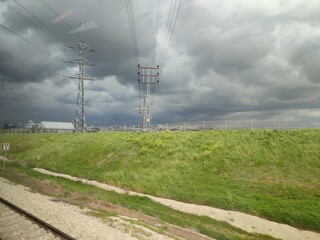 power lines, green nature, gray clouds 