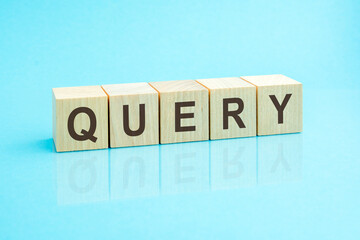 wooden blocks with the word query, blue background