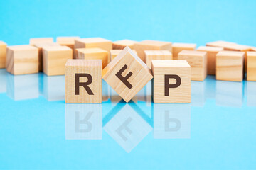 RFP text is made of wooden building blocks lying on the bright blue table, concept