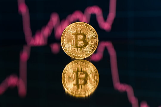 Bitcoin cryptocurrency trading chart background. Bitcoin price low on the chart with red indicator sign.