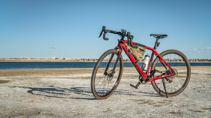 Fototapeta na wymiar lightweight gravel or touring bike with a carbon frame on a lake shore - Boyd Lake State Park, Colorado