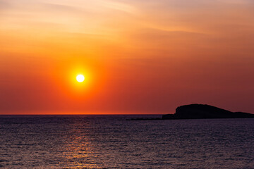 Fototapeta na wymiar Orange sunset over a sea