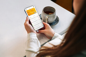 E banking concept. Girl holding mobile phone with internet online bank app. Credit card wallet application. Online wallet save money.