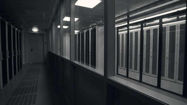 Shot of Corridor in Working Data Center Full of Rack Servers and Supercomputers with High Internet Visualisation Projection. IT sector, technologies concept