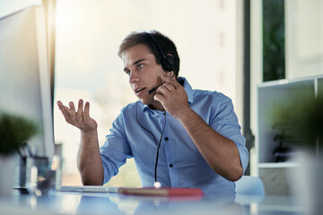Talking a client through resolving their issue. Cropped shot of a call centre agent working in an...