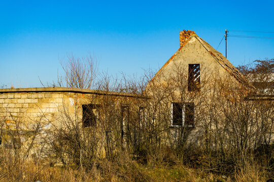 old dilapidated abandoned house on a vacant lot.