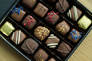 Box of delicious handmade chocolates. Fancy gift box of assorted candies or truffles. 