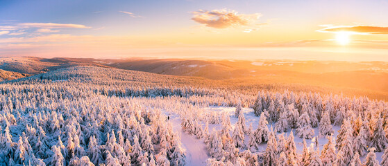 Winter landscape in the mountains at sunset, snow-capped mountain peaks and forest, the view from...