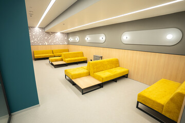 Empty modern waiting room in business center with sofas